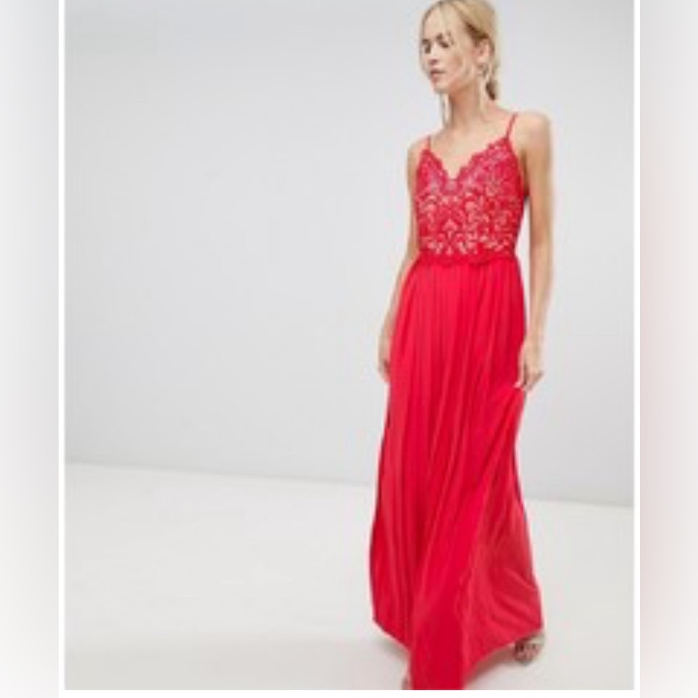 Formal red gown with spaghetti straps, lace bodice, and pleated full skirt